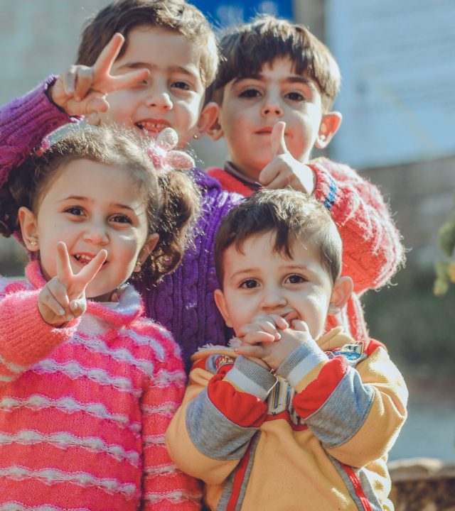 Children showing the peace sign
